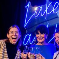 President Mantella cheers with two grads
